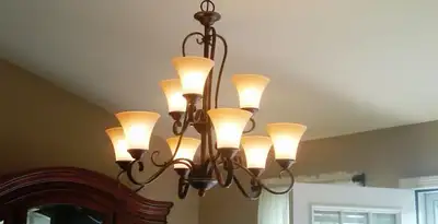 Classic ceiling chandelier installation with warm lighting in Baton Rouge, LA