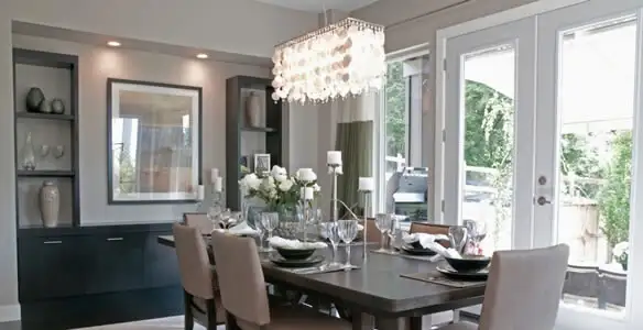 Elegant dining room chandelier installation above table in Baton Rouge, LA