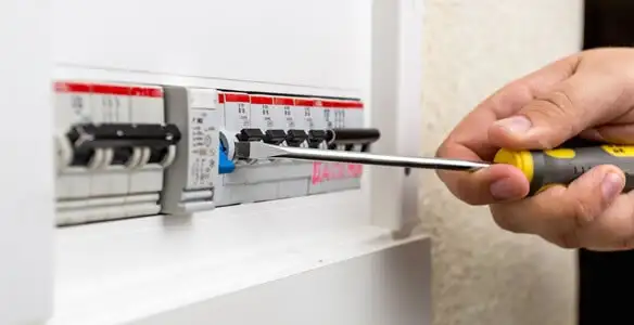 electrical panel upgrade service showing technician adjusting circuit breakers during system upgrade in Baton Rouge, LA