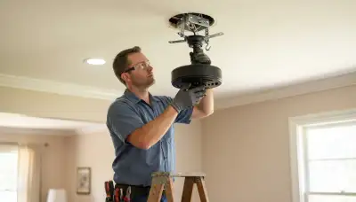 Electrician installs a fan-rated ceiling box and mounting bracket in a Baton Rouge, LA home