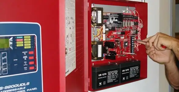 fire alarm installation service showing technician configuring fire alarm control panel in Baton Rouge, LA