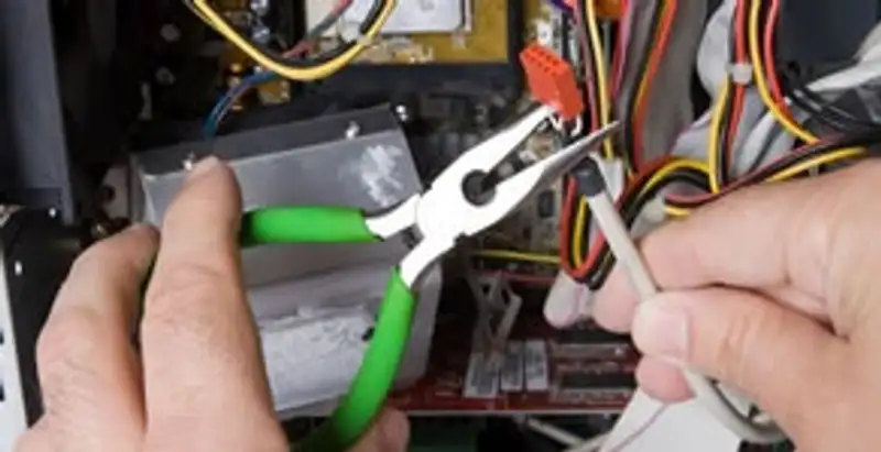 Licensed electrical contractor performing electrical repair with tools in Addis, LA