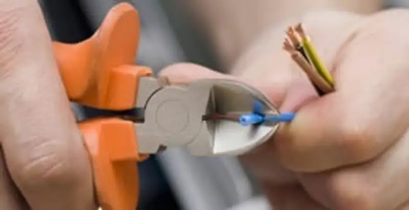 licensed electrician performing precise wire cutting and preparation during electrical service in Baton Rouge, LA