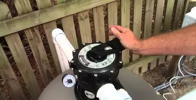 pool pumps service showing professional adjustment of pool pump control system in Baton Rouge, LA